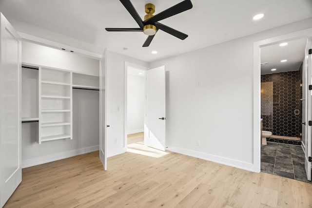 unfurnished bedroom with ceiling fan, ensuite bath, a closet, and light hardwood / wood-style flooring