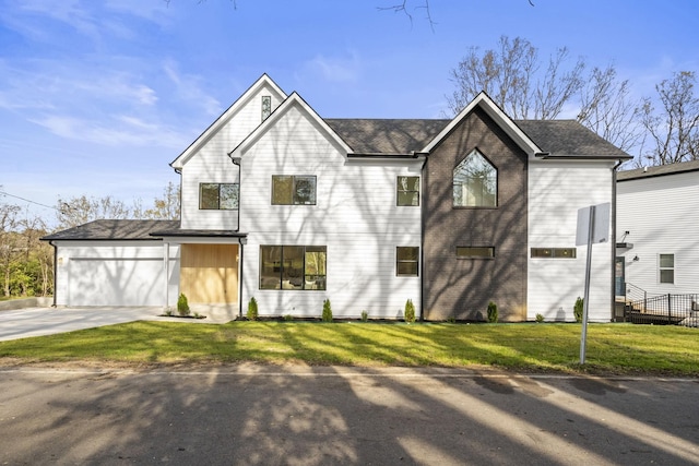 view of front of house featuring a garage and a front yard