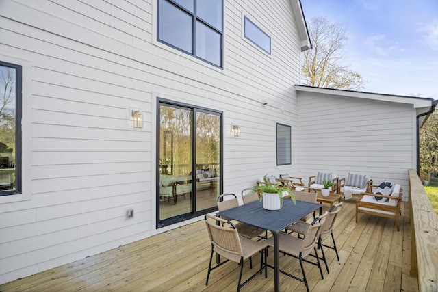 wooden terrace with an outdoor hangout area