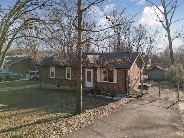 single story home with a storage shed and a front lawn