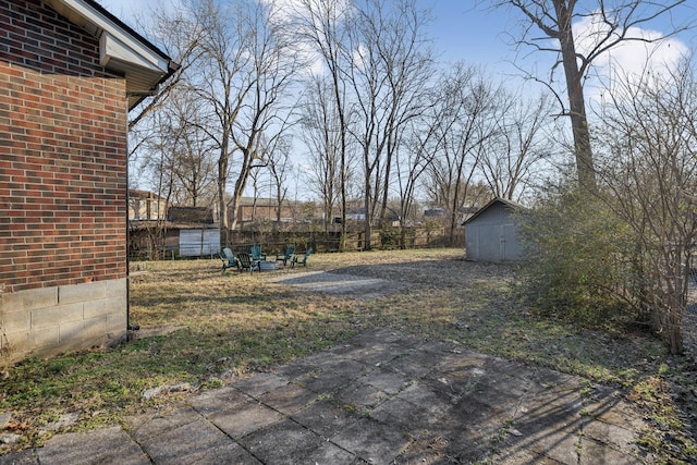 view of yard with a storage shed and a patio