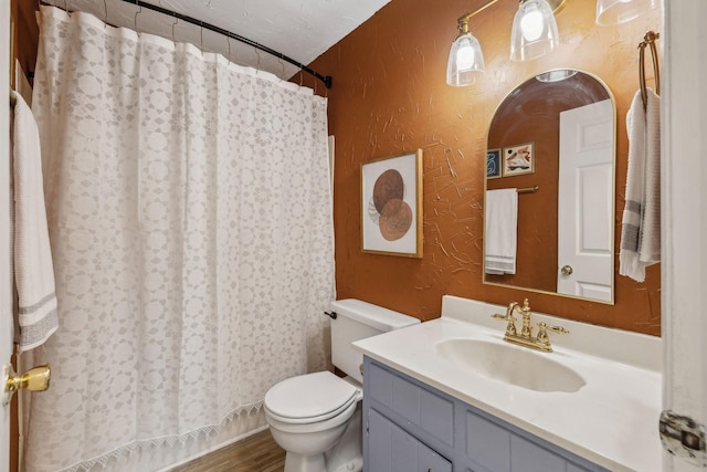 bathroom with vanity, a textured ceiling, and toilet