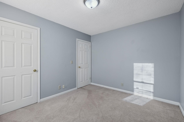 carpeted spare room featuring a textured ceiling