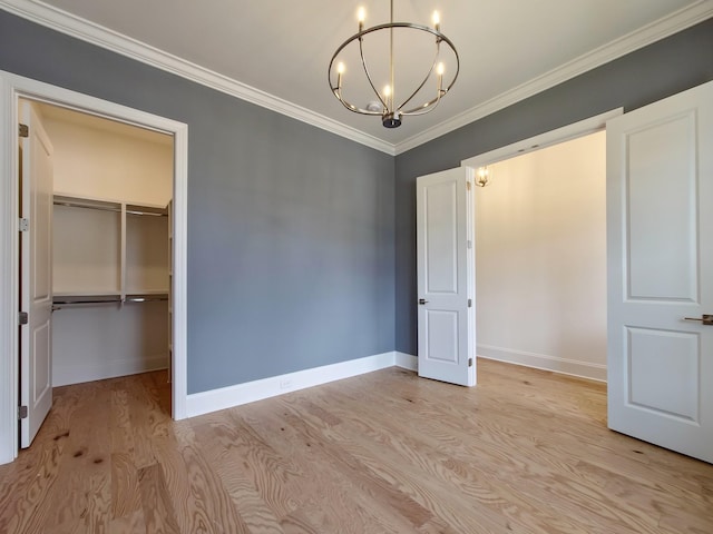 interior space featuring a notable chandelier, light hardwood / wood-style flooring, ornamental molding, and a closet