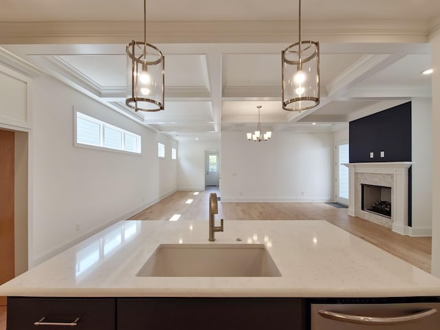 kitchen featuring beamed ceiling, stainless steel dishwasher, coffered ceiling, and sink