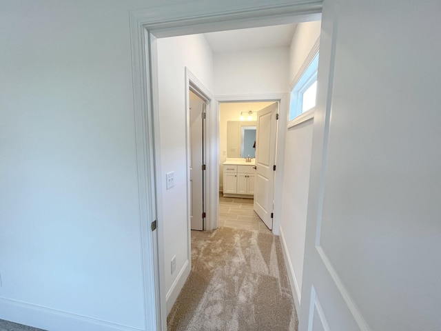 hallway with light colored carpet