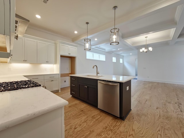 kitchen featuring white cabinetry, sink, stainless steel appliances, and an island with sink