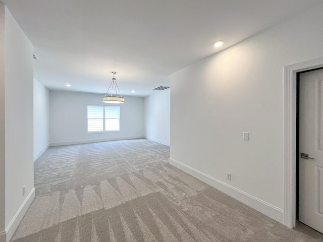 unfurnished room with light carpet