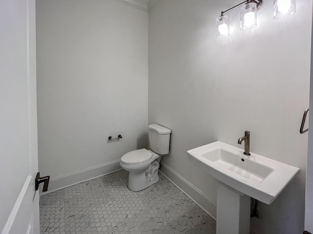 bathroom featuring sink, ornamental molding, toilet, and tile patterned flooring