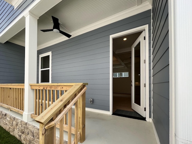 entrance to property with a patio and ceiling fan