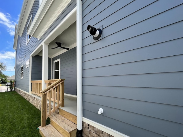 exterior space featuring a yard and ceiling fan