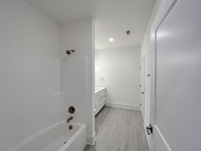 bathroom featuring vanity and bathing tub / shower combination