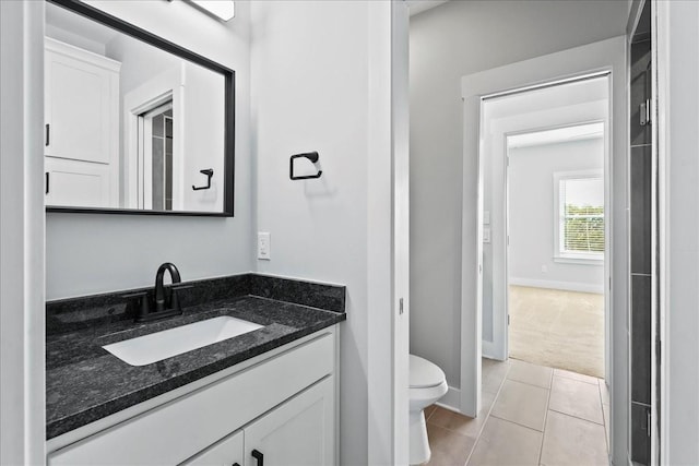 bathroom with vanity, tile patterned floors, and toilet