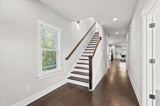 stairs with hardwood / wood-style flooring