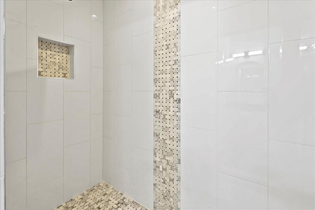 bathroom with a tile shower