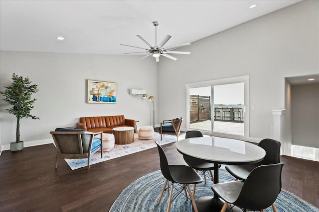 dining room featuring ceiling fan, a wall mounted air conditioner, dark hardwood / wood-style flooring, and vaulted ceiling