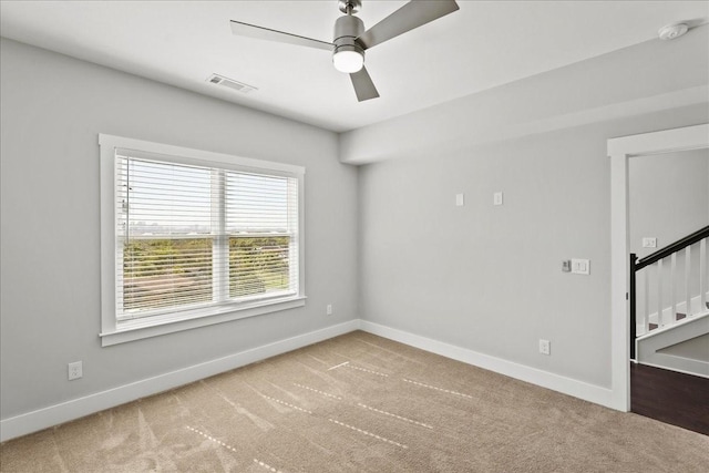 carpeted empty room with ceiling fan