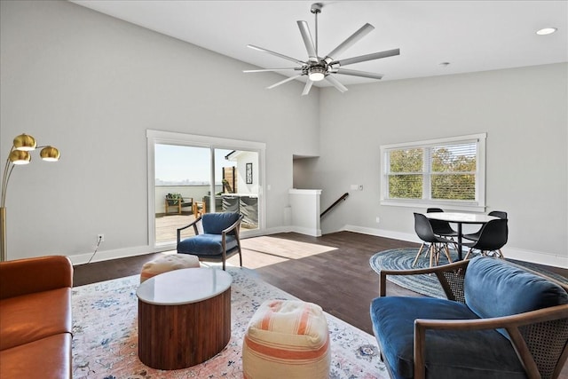 living room featuring ceiling fan, plenty of natural light, dark hardwood / wood-style flooring, and vaulted ceiling