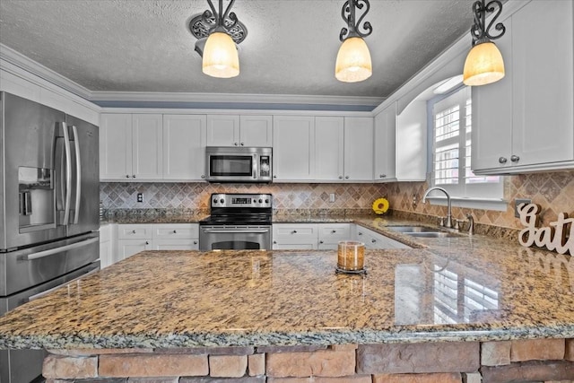 kitchen with sink, appliances with stainless steel finishes, white cabinetry, ornamental molding, and decorative light fixtures