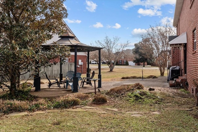 view of yard with a gazebo, a patio area, and an outdoor fire pit