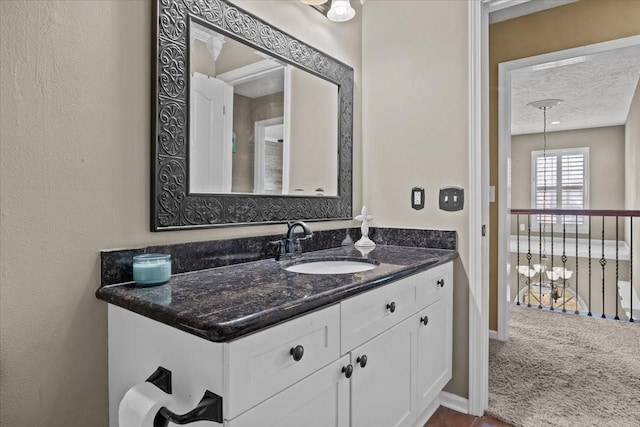 bathroom featuring vanity and a textured ceiling