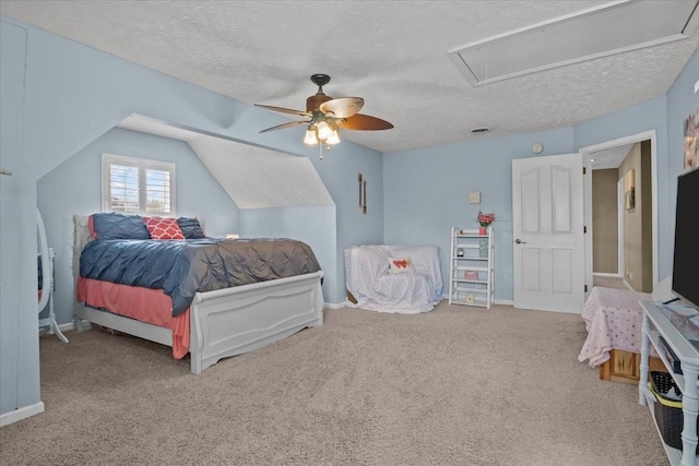 carpeted bedroom featuring vaulted ceiling, a textured ceiling, and ceiling fan