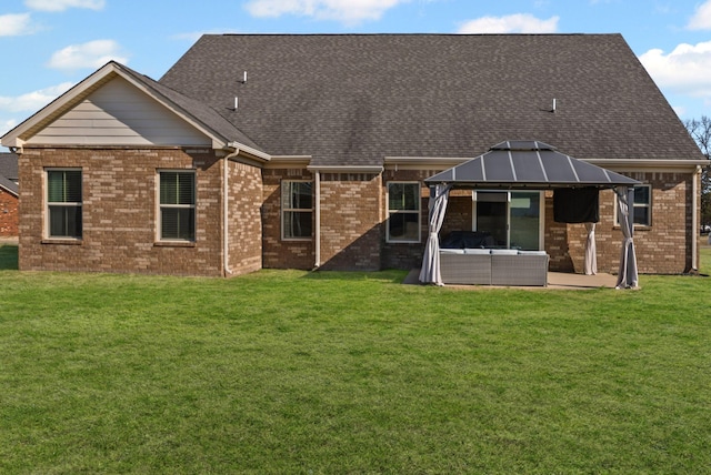 rear view of property featuring an outdoor living space, a gazebo, a lawn, and a patio