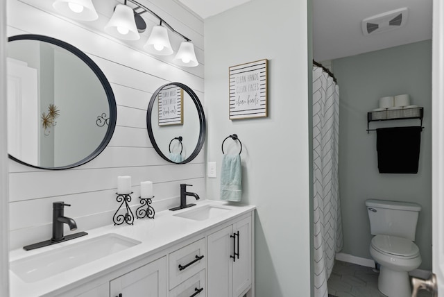 bathroom featuring vanity, tile patterned floors, and toilet