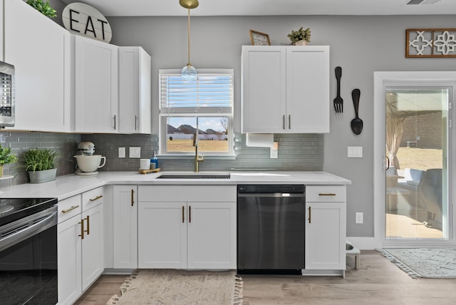 kitchen with white cabinetry, black dishwasher, and electric range