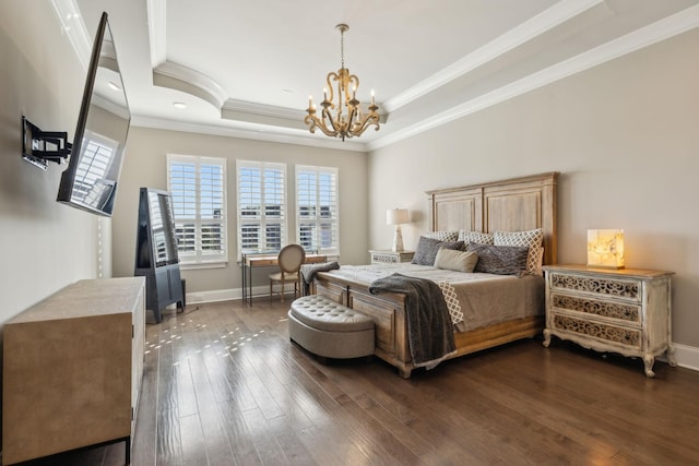 bedroom with crown molding, a tray ceiling, dark wood-type flooring, and a chandelier