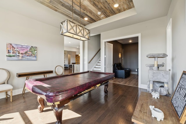 game room featuring a fireplace, dark hardwood / wood-style flooring, pool table, wooden ceiling, and a raised ceiling