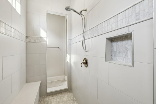 bathroom with tile patterned floors and a tile shower