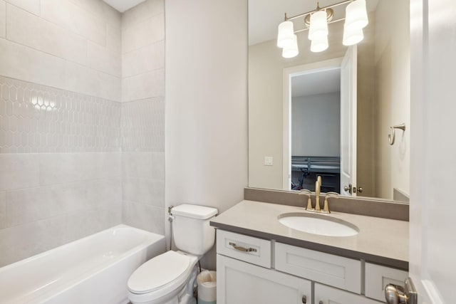 full bathroom featuring vanity, tiled shower / bath, and toilet