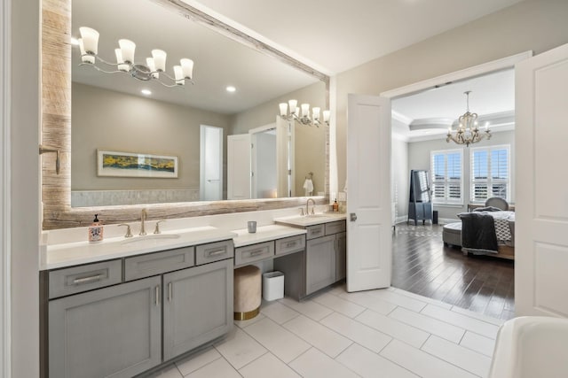 bathroom with vanity, tile patterned floors, and a chandelier