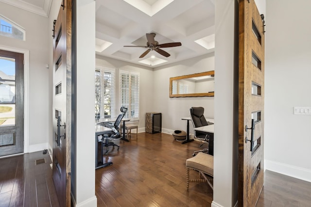 office space featuring coffered ceiling, beamed ceiling, a barn door, and a healthy amount of sunlight