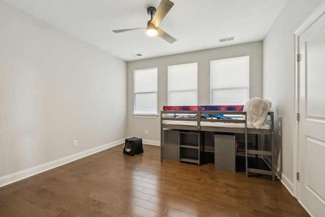 office area featuring dark wood-type flooring and ceiling fan