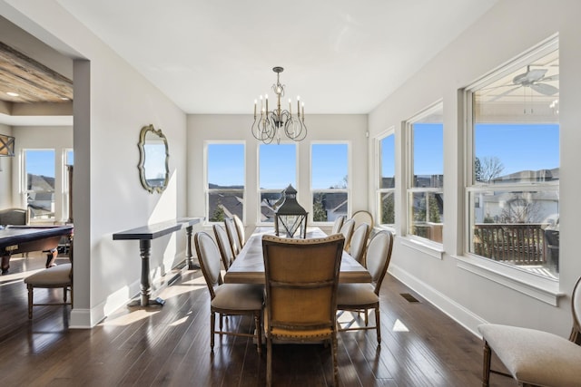 dining room with dark hardwood / wood-style flooring and a notable chandelier