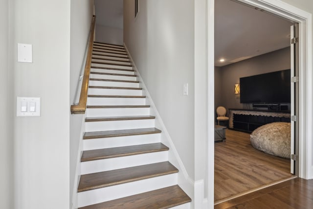 staircase featuring wood-type flooring