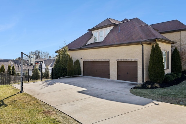 view of property exterior with a garage and a lawn