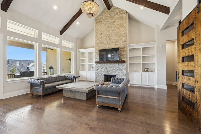 living room featuring high vaulted ceiling, a fireplace, beamed ceiling, dark hardwood / wood-style flooring, and a chandelier