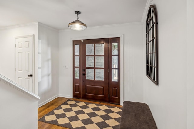 foyer with ornamental molding and dark hardwood / wood-style flooring