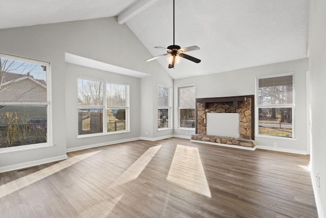 unfurnished living room with beam ceiling, wood-type flooring, high vaulted ceiling, ceiling fan, and a fireplace