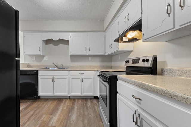 kitchen with sink, white cabinets, a textured ceiling, and black appliances