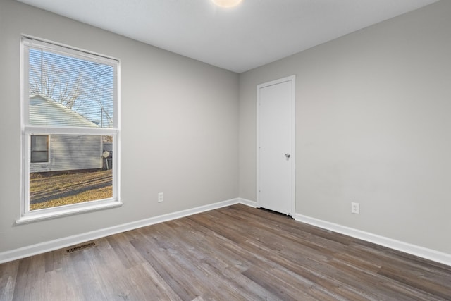 empty room featuring hardwood / wood-style flooring and plenty of natural light