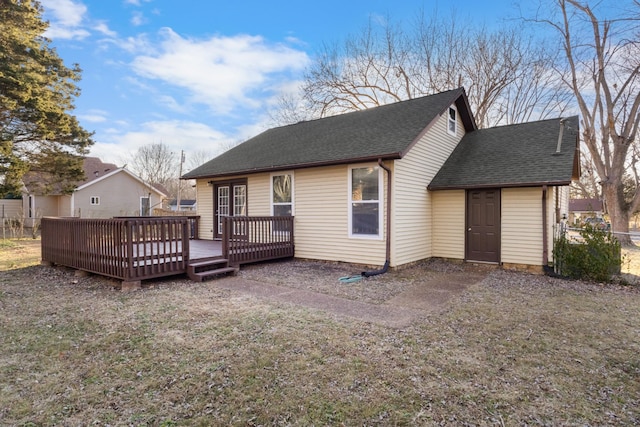 back of property featuring a yard and a deck