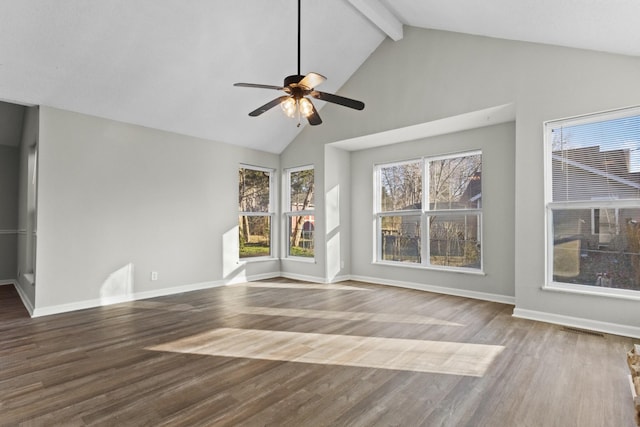 unfurnished living room featuring wood-type flooring, high vaulted ceiling, ceiling fan, and beam ceiling