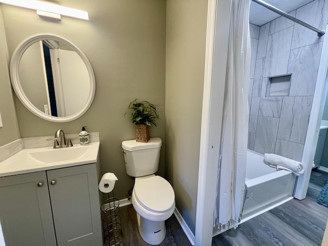 full bathroom with hardwood / wood-style flooring, vanity, shower / bath combo with shower curtain, and toilet