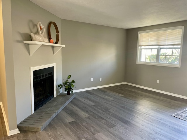 unfurnished living room with dark hardwood / wood-style floors