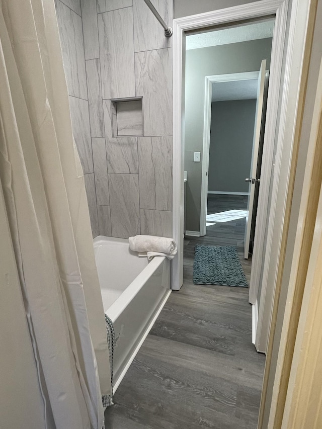 bathroom featuring hardwood / wood-style flooring and shower / tub combo