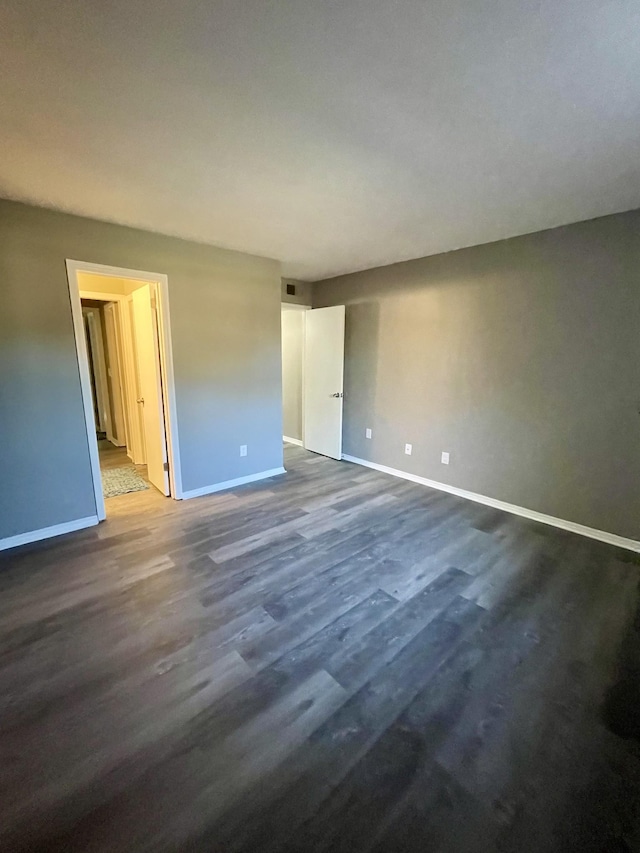 empty room featuring dark hardwood / wood-style flooring